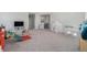 Bright playroom with plush carpeting, neutral walls, and modern kid-friendly furnishings for a fun and safe environment at 22990 Scaglione Dr, Lutz, FL 33549
