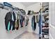 Well-organized walk-in closet featuring multiple hanging rods and shelves for efficient storage at 22990 Scaglione Dr, Lutz, FL 33549