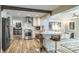 Modern kitchen featuring stainless steel appliances, white cabinets, and an island with bar seating at 230 S Julia Cir, St Pete Beach, FL 33706