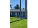 Inviting facade with manicured lawn and tropical trees creating a serene and picturesque setting at 230 S Julia Cir, St Pete Beach, FL 33706