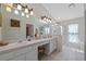 Bright bathroom featuring dual sinks, vanity area, and a glass-enclosed shower for a spa-like experience at 25311 Lexington Oaks Blvd, Wesley Chapel, FL 33544