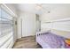 Bedroom featuring wood floors, bunk bed, bright windows, and white sliding closet at 2905 Bay St, Sarasota, FL 34237