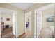 Hallway view featuring doorways to bedrooms with wood-style flooring and neutral paint at 2905 Bay St, Sarasota, FL 34237