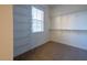 Bright walk-in closet featuring carpeted floor, shelving, and natural light from a window at 3010 W Stovall St # B, Tampa, FL 33629