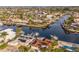 Scenic aerial view showcases waterfront homes with private docks nestled along a tranquil canal and beautiful coastline at 3939 Rudder Way, New Port Richey, FL 34652