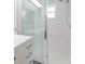 Bright bathroom featuring a tiled shower with glass door and modern fixtures at 3939 Rudder Way, New Port Richey, FL 34652