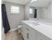 Bright bathroom with a vanity, large mirror, and combination shower-tub at 3939 Rudder Way, New Port Richey, FL 34652