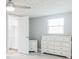 Bright bedroom with an ensuite bath, ceiling fan, and a large dresser at 3939 Rudder Way, New Port Richey, FL 34652