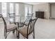Bright dining room with glass table, seating for four, and a neutral color palette at 3939 Rudder Way, New Port Richey, FL 34652