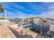 Waterfront view of a private dock with boat lifts and outdoor seating at 3939 Rudder Way, New Port Richey, FL 34652
