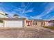 Single Gathering home featuring a two car garage, stone accents and a red front door at 3939 Rudder Way, New Port Richey, FL 34652