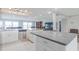 Open concept kitchen features stainless steel appliances, white cabinets and granite countertops at 3939 Rudder Way, New Port Richey, FL 34652