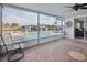 Enclosed lanai with in-ground pool, waterfront views, and decorative tile flooring at 3939 Rudder Way, New Port Richey, FL 34652
