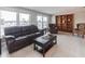 Comfortable living room featuring a leather sofa, a bookcase, and an accent chair at 3939 Rudder Way, New Port Richey, FL 34652