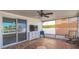 Enclosed patio featuring sliding glass doors and mosaic tile flooring at 3939 Rudder Way, New Port Richey, FL 34652