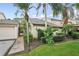 Charming villa featuring lush tropical landscaping, a private walkway, and a meticulously kept lawn at 4307 Woodmans Chart # 132, Sarasota, FL 34235