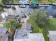 Aerial view of waterfront property with boat dock, rooftop patio, and lush landscaping at 5033 Blue Heron Dr, New Port Richey, FL 34652