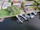 Aerial view of a waterfront property with boat docks and lifts, providing direct access to waterways and boating opportunities at 5033 Blue Heron Dr, New Port Richey, FL 34652