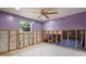 Bedroom showing studs for new walls with natural light and ceiling fan at 5033 Blue Heron Dr, New Port Richey, FL 34652