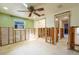 Bedroom showing studs for new walls with natural light and ceiling fan at 5033 Blue Heron Dr, New Port Richey, FL 34652