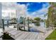 Waterfront property featuring a private boat dock with boat lift and beautiful views of the canal and surrounding neighborhood at 5033 Blue Heron Dr, New Port Richey, FL 34652