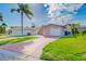 Charming single-Gathering home with a one-car garage, brick driveway and a well-maintained front yard at 5033 Blue Heron Dr, New Port Richey, FL 34652