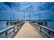 Picturesque waterfront view from the private boat dock with boats sailing on the horizon under a cloudy sky at 5200 Brittany S Dr # 902, St Petersburg, FL 33715