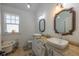 Bright bathroom featuring double vessel sinks, granite countertops, and a vintage clawfoot tub at 602 Nw Drane St, Plant City, FL 33563