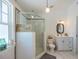 Bright bathroom with glass enclosed shower, stylish vanity, and decorative shark art at 602 Nw Drane St, Plant City, FL 33563