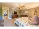 Comfortable bedroom features a colorful quilt, TV, and a separate play area at 602 Nw Drane St, Plant City, FL 33563