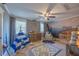 Charming Bedroom with a crib, gray accent wall, tent and decorative mural at 602 Nw Drane St, Plant City, FL 33563