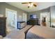 Grey bedroom with bathroom and dresser, and doorway into another room at 602 Nw Drane St, Plant City, FL 33563