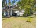 Spacious carport of a two-story home with a well-maintained lawn at 602 Nw Drane St, Plant City, FL 33563