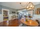 Open dining area with hardwood floors, chandelier, and views of the kitchen and bedroom at 602 Nw Drane St, Plant City, FL 33563
