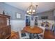 Cozy dining room featuring wood floors, wainscoting, and a unique chandelier over an oval table at 602 Nw Drane St, Plant City, FL 33563