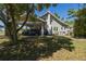 Charming two-story home with a convenient carport and mature trees at 602 Nw Drane St, Plant City, FL 33563