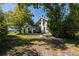 Two-story home featuring a carport, mature trees, and a well-kept driveway at 602 Nw Drane St, Plant City, FL 33563