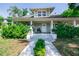Charming two-story home boasts a welcoming front porch and lush landscaping at 602 Nw Drane St, Plant City, FL 33563