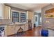 Cozy kitchen with stainless steel appliances, white cabinets, and hardwood flooring at 602 Nw Drane St, Plant City, FL 33563
