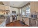 Cozy kitchen with stainless steel appliances, white cabinets, and hardwood flooring at 602 Nw Drane St, Plant City, FL 33563
