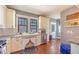 Cozy kitchen with stainless steel appliances, white cabinets, and hardwood flooring at 602 Nw Drane St, Plant City, FL 33563