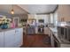 Bright kitchen with white cabinets, stainless steel appliances, and hardwood floors at 602 Nw Drane St, Plant City, FL 33563