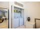 Laundry closet with white washer/dryer, storage, and a 'wash/dry' sign overhead at 602 Nw Drane St, Plant City, FL 33563