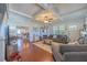 Bright living room featuring a decorative fireplace, hardwood floors, and a view into the kitchen at 602 Nw Drane St, Plant City, FL 33563
