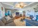 Inviting living room with hardwood floors, gray sofa, stairs to the second floor and connecting to the kitchen at 602 Nw Drane St, Plant City, FL 33563