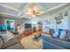 Inviting living room with hardwood floors, fireplace, gray sofas, and stairs to the second floor at 602 Nw Drane St, Plant City, FL 33563