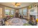Play room with windows and a ceiling fan, and a fireplace at 602 Nw Drane St, Plant City, FL 33563