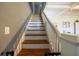 Staircase with wooden steps and white railings, leading to upper level at 602 Nw Drane St, Plant City, FL 33563
