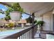 Balcony view overlooking a community pool and landscaped grounds, enhanced with hanging plants at 6308 Newtown Cir # 8C5, Tampa, FL 33615