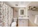 Bright bathroom featuring modern vanity and fixtures and a shower with a floral curtain at 6308 Newtown Cir # 8C5, Tampa, FL 33615